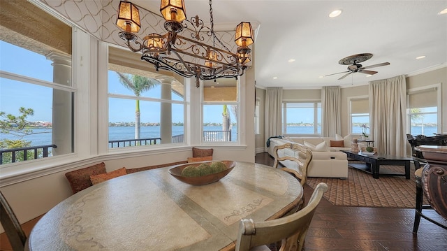 dining room featuring recessed lighting, a water view, and a healthy amount of sunlight
