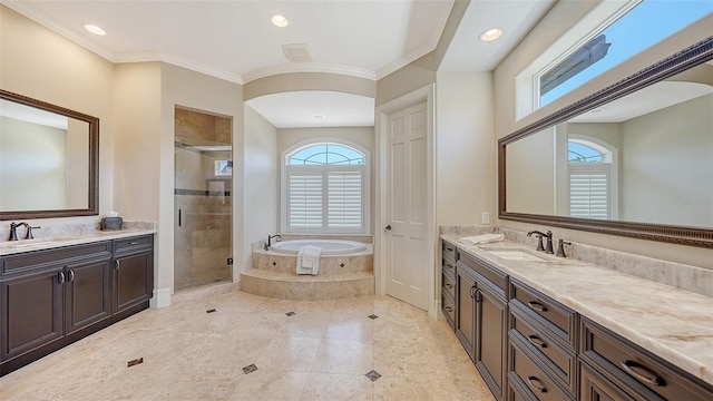bathroom with a sink, a bath, a stall shower, and two vanities