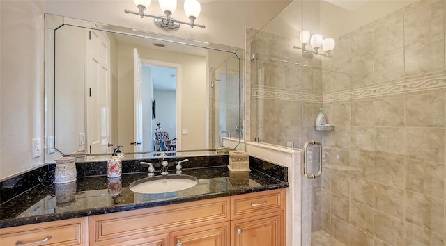 bathroom featuring a shower stall and vanity