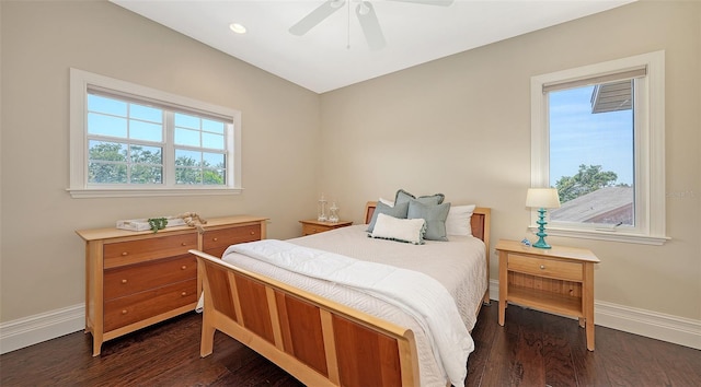 bedroom featuring baseboards, dark wood finished floors, and ceiling fan