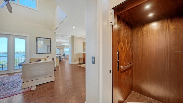 interior space featuring ceiling fan, dark wood-style flooring, baseboards, elevator, and recessed lighting
