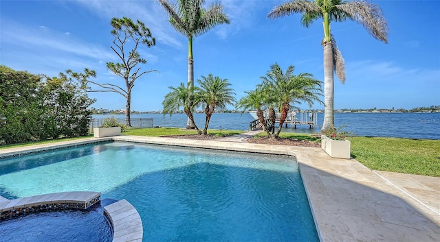 outdoor pool with a patio and a water view