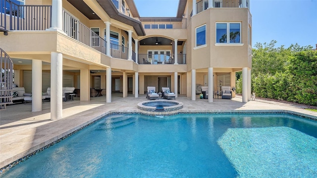 pool featuring an in ground hot tub, a patio area, and outdoor lounge area