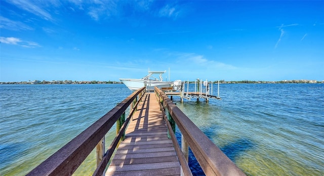 dock area featuring boat lift and a water view
