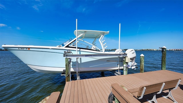 view of dock with boat lift and a water view