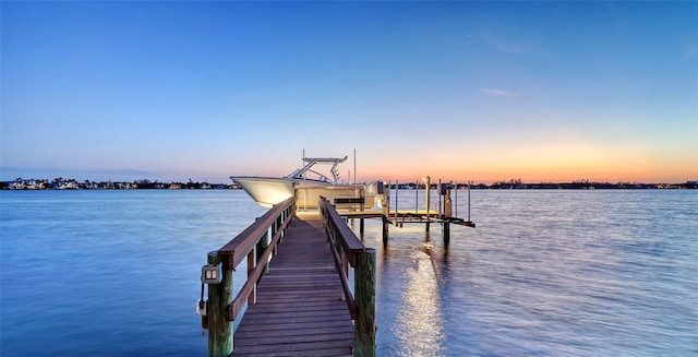 dock area with a water view and boat lift