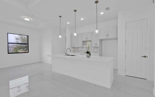 kitchen featuring white cabinetry, a sink, visible vents, light countertops, and recessed lighting