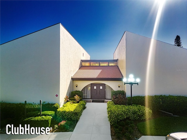 view of front of house with stucco siding and a tiled roof