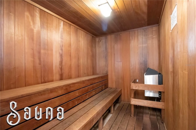 relaxing sauna featuring wood walls and wood ceiling
