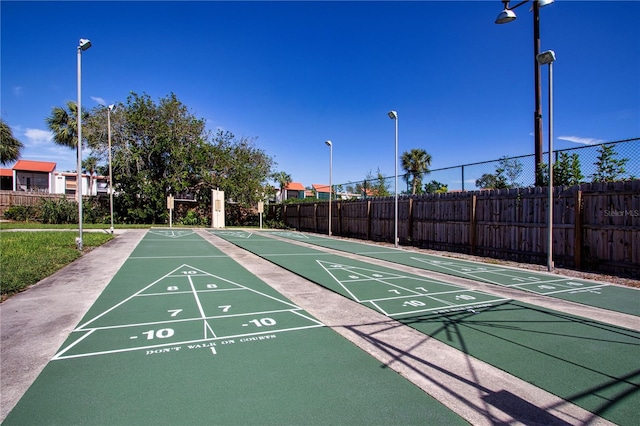 surrounding community with fence and shuffleboard