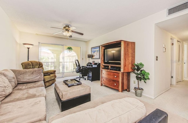 carpeted living room with ceiling fan and baseboards