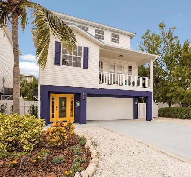 view of front facade with fence, driveway, and a garage