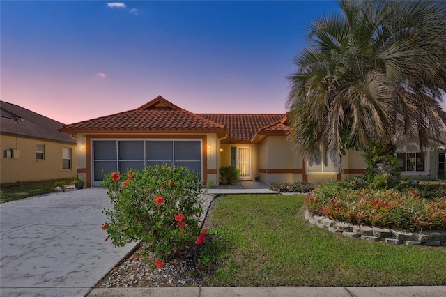 6415 39th Ave W, Bradenton, FL 34209 - view of front of property featuring a garage, a front yard, stucco siding, a tiled roof, and concrete driveway