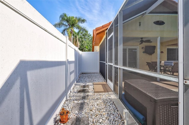 6415 39th Ave W, Bradenton, FL 34209 - view of property exterior featuring a fenced backyard, a ceiling fan, and a lanai