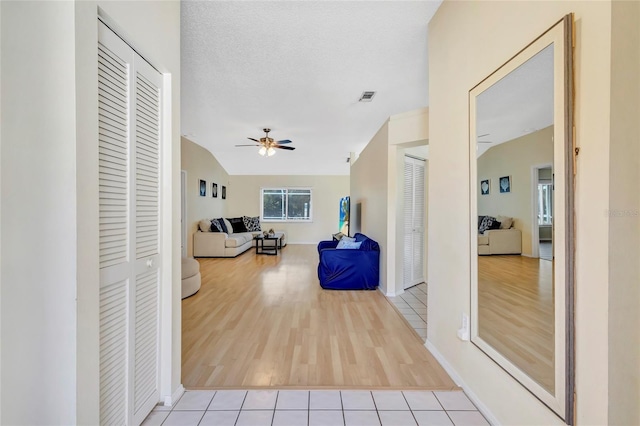6415 39th Ave W, Bradenton, FL 34209 - corridor featuring baseboards, lofted ceiling, wood finished floors, and visible vents