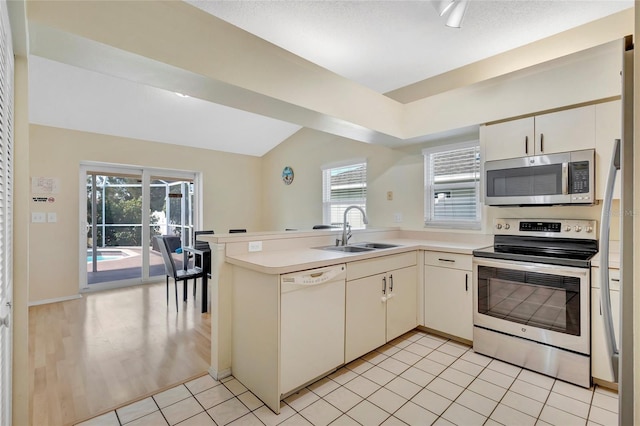 6415 39th Ave W, Bradenton, FL 34209 - kitchen with light countertops, a sink, a peninsula, and stainless steel appliances