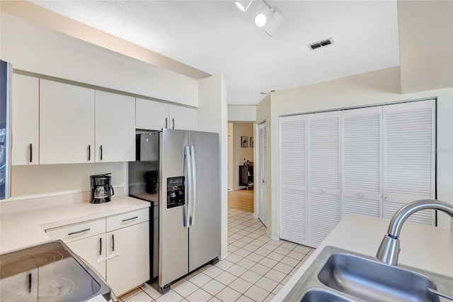 6415 39th Ave W, Bradenton, FL 34209 - kitchen with light tile patterned flooring, light countertops, stainless steel fridge with ice dispenser, a sink, and range