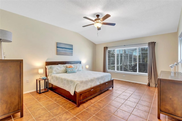 6415 39th Ave W, Bradenton, FL 34209 - bedroom featuring baseboards, a ceiling fan, light tile patterned floors, and vaulted ceiling