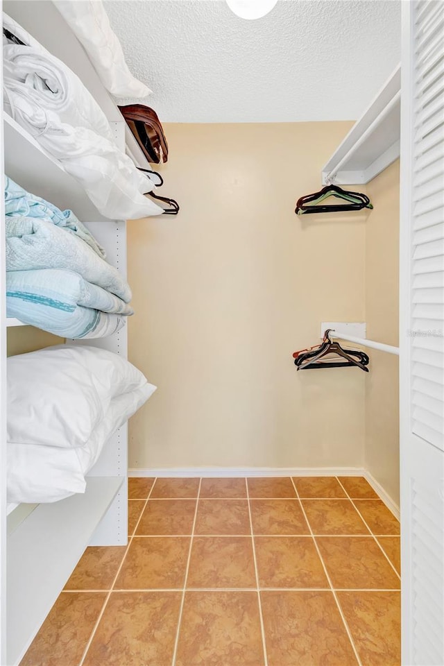 6415 39th Ave W, Bradenton, FL 34209 - spacious closet featuring light tile patterned floors