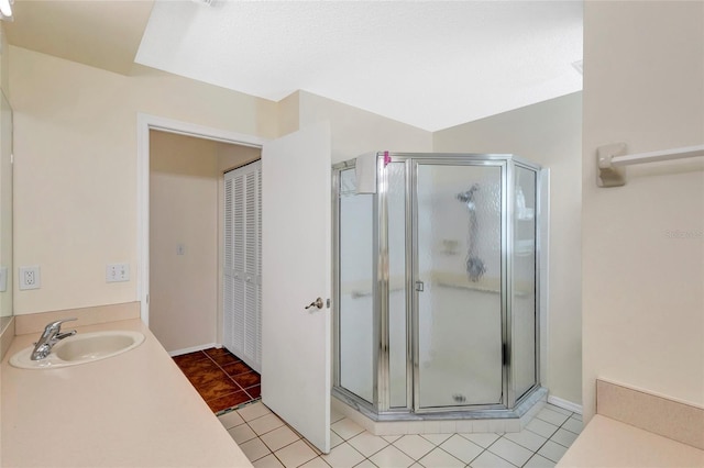 6415 39th Ave W, Bradenton, FL 34209 - full bathroom featuring vanity, tile patterned floors, and a shower stall