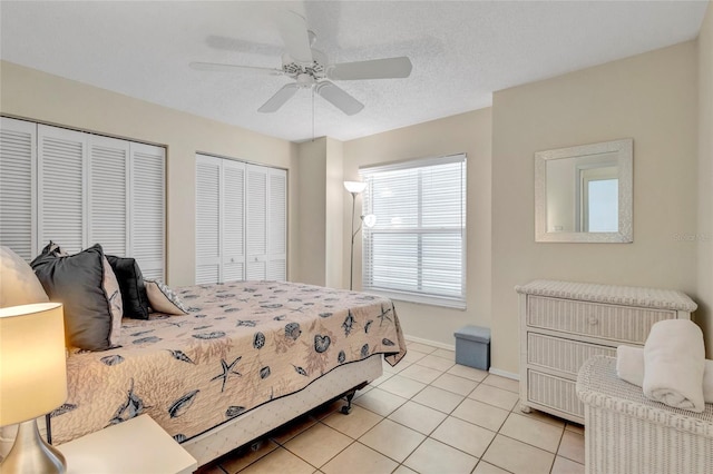 6415 39th Ave W, Bradenton, FL 34209 - bedroom featuring light tile patterned floors, multiple closets, baseboards, and ceiling fan