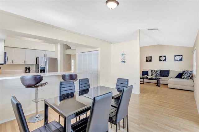 6415 39th Ave W, Bradenton, FL 34209 - dining area featuring baseboards, vaulted ceiling, light wood-style flooring, and visible vents