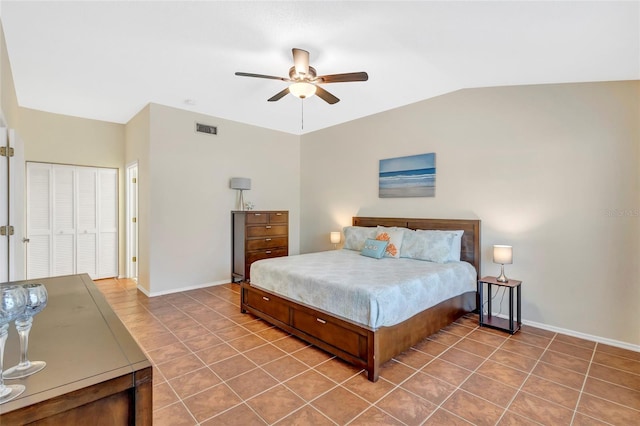 6415 39th Ave W, Bradenton, FL 34209 - tiled bedroom with a closet, baseboards, vaulted ceiling, and visible vents