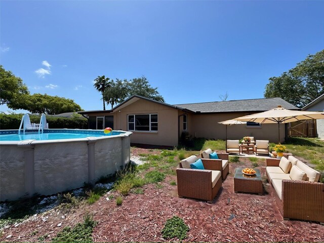 9430 Glen Moor Ln, Port Richey, FL 34668 - back of house with an outdoor living space with a fire pit and an outdoor pool