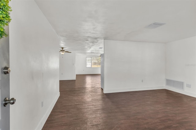 9430 Glen Moor Ln, Port Richey, FL 34668 - empty room with baseboards, dark wood finished floors, and a ceiling fan