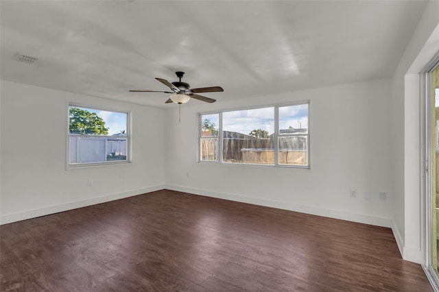 9430 Glen Moor Ln, Port Richey, FL 34668 - unfurnished room with plenty of natural light, dark wood-type flooring, baseboards, and a ceiling fan