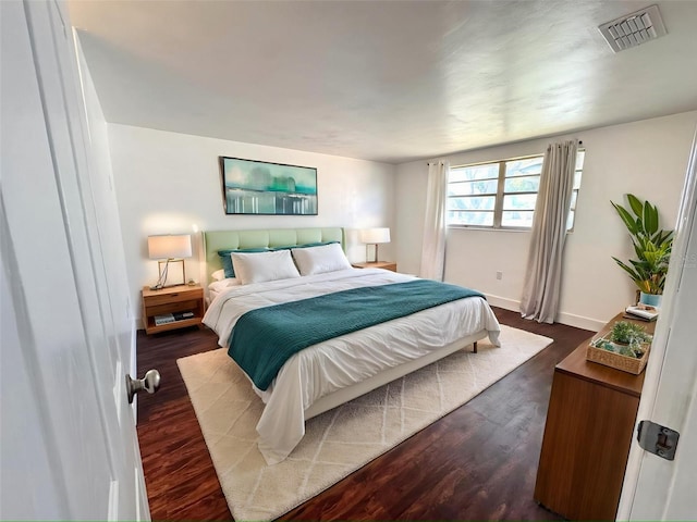 9430 Glen Moor Ln, Port Richey, FL 34668 - bedroom with dark wood-style floors and baseboards
