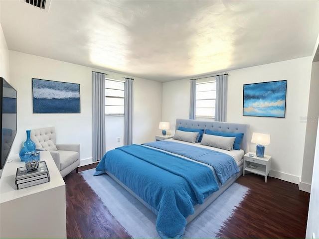 9430 Glen Moor Ln, Port Richey, FL 34668 - bedroom with wood finished floors, baseboards, and multiple windows