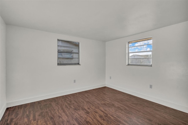 9430 Glen Moor Ln, Port Richey, FL 34668 - unfurnished room with baseboards and dark wood-style floors