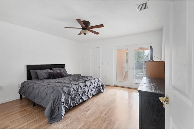 bedroom featuring access to exterior, visible vents, light wood-style flooring, and french doors