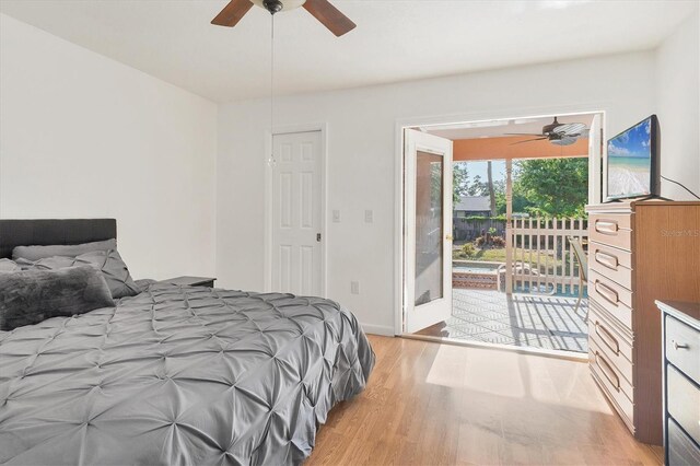bedroom featuring baseboards, light wood-type flooring, a ceiling fan, and access to outside