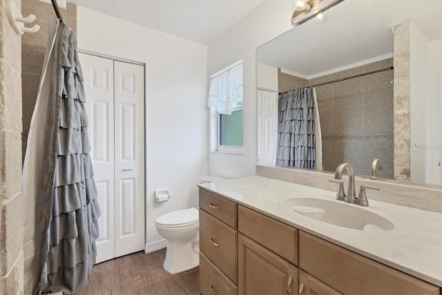 bathroom featuring wood finished floors, toilet, a shower with curtain, and vanity