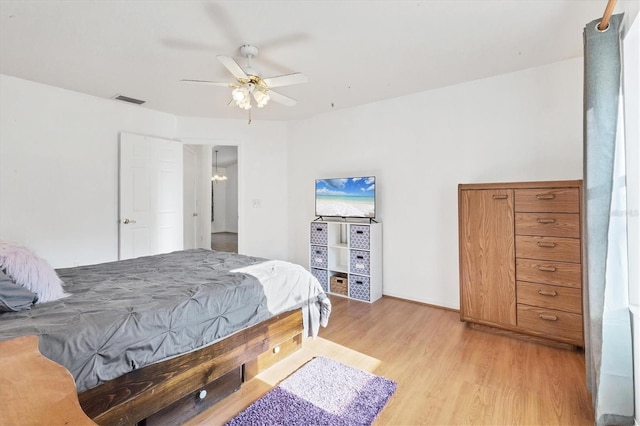 bedroom featuring visible vents, ceiling fan, and light wood finished floors