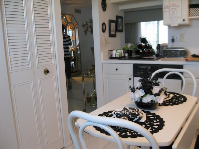 kitchen featuring white cabinets, visible vents, and dishwasher