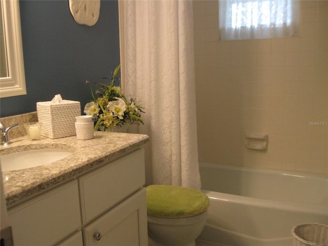 bathroom with shower / bath combo with shower curtain, vanity, and toilet