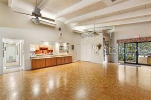 interior space with beamed ceiling, a ceiling fan, and a high ceiling