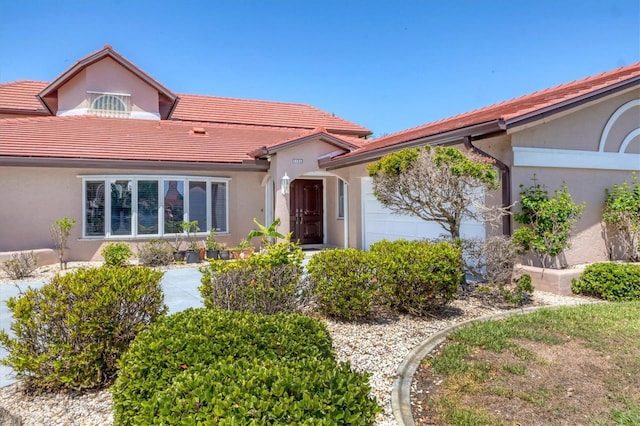 4405 Harbor Blvd, Port Charlotte, FL 33952 - view of front of property with an attached garage, stucco siding, and a tile roof