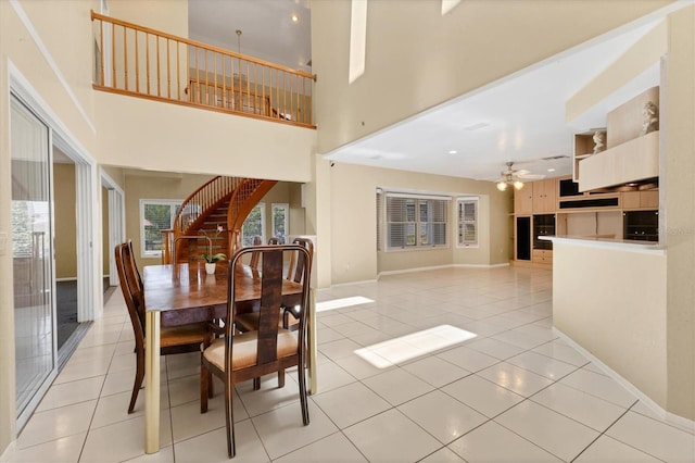 4405 Harbor Blvd, Port Charlotte, FL 33952 - dining area with light tile patterned floors, a ceiling fan, a high ceiling, and baseboards