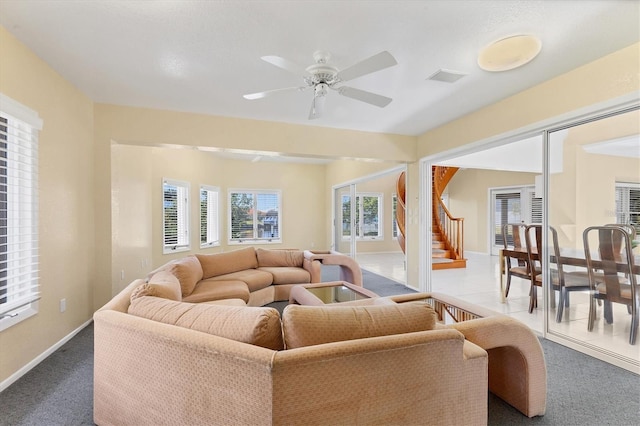 4405 Harbor Blvd, Port Charlotte, FL 33952 - living area with dark colored carpet, ceiling fan, baseboards, and stairway