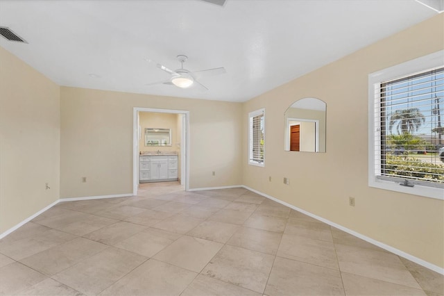 4405 Harbor Blvd, Port Charlotte, FL 33952 - empty room featuring light tile patterned floors, a ceiling fan, and baseboards