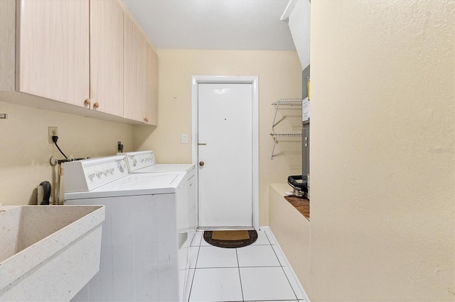 4405 Harbor Blvd, Port Charlotte, FL 33952 - washroom featuring separate washer and dryer, cabinet space, and light tile patterned floors