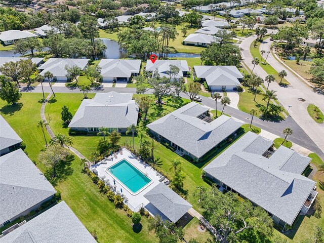 drone / aerial view with a water view and a residential view