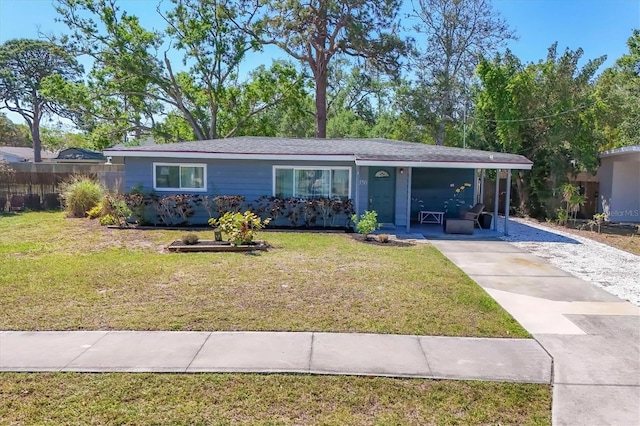 ranch-style home with a front lawn and concrete driveway