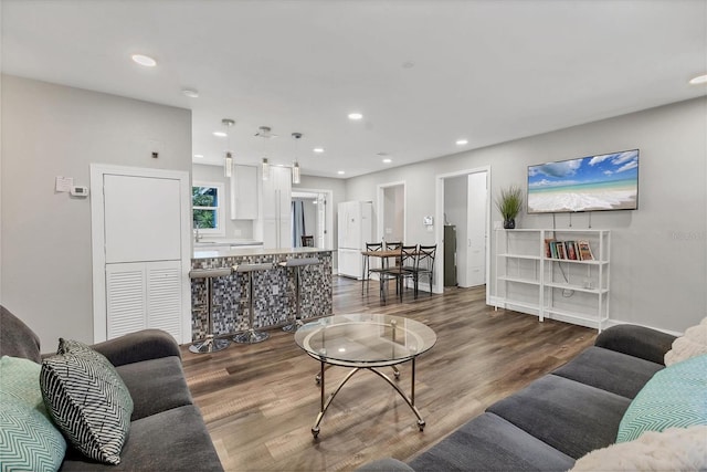 living room with wood finished floors and recessed lighting