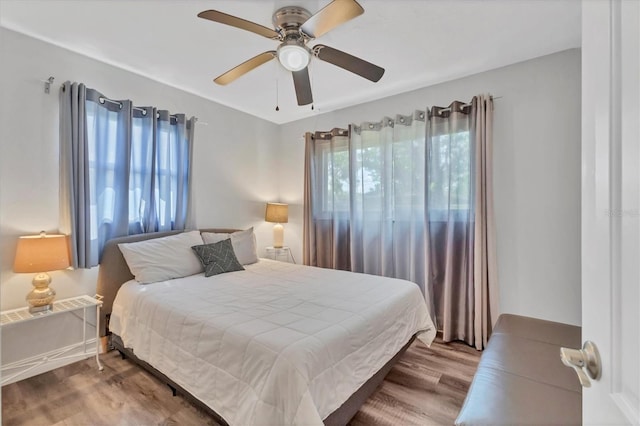 bedroom with a ceiling fan and wood finished floors