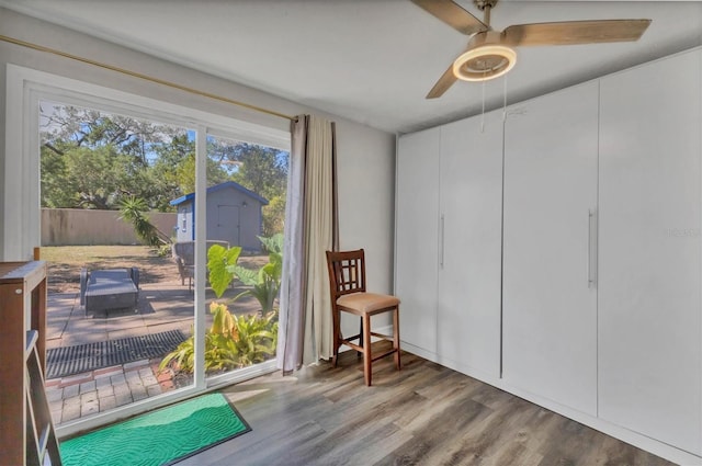 sitting room with ceiling fan and wood finished floors
